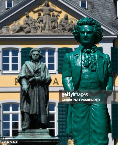 Sculpture representing German composer Ludwig van Beethoven and made by conceptual artist Ottmar Hoerl is displayed next to a bronze statue of...