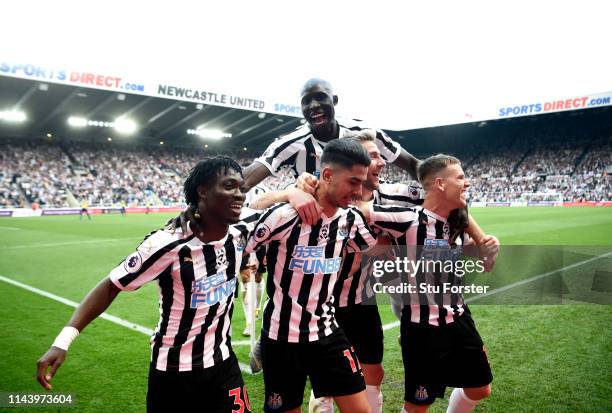 Ayoze Perez of Newcastle United celebrates with teammates after scoring his team's third goal during the Premier League match between Newcastle...