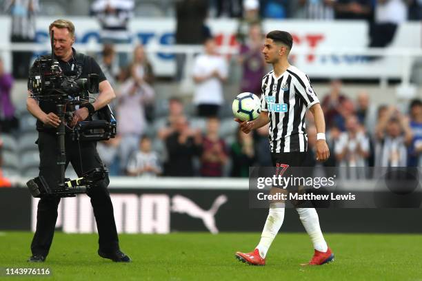 Ayoze Perez of Newcastle United leaves the pitch with the match ball following his hat-trick during the Premier League match between Newcastle United...