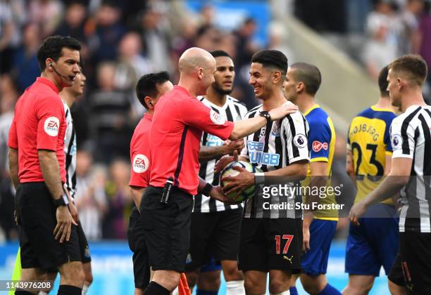 Referee Anthony Taylor gives Ayoze Perez of Newcastle United the match ball following his hat-trick during the Premier League match between Newcastle...