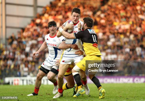 Sam James of Sale Sharks is tackled by Arthur Retiere of Stade Rochelais during the Challenge Cup Semi Final match between La Rochelle and Sale...