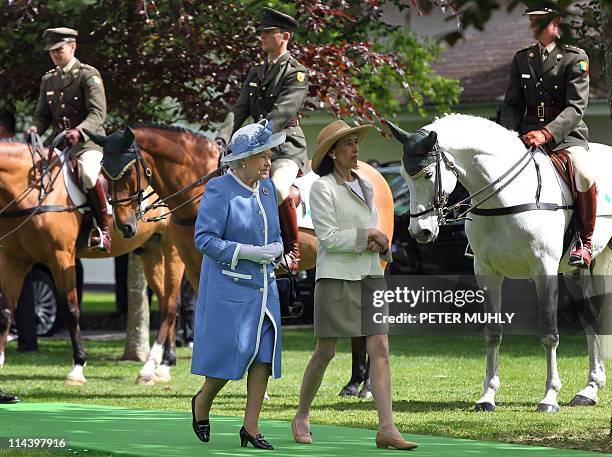 Britain's Queen Elizabeth II views horses and riders from the Irish Army Equitation school with Chryss O'Reilly, Chair of the board of the Irish...