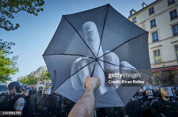 Gilet Jaune mocks the authority of French Riot Police with his umbrella at Place de la Republique during Act 23 of Gilets Jaunes or 'Yellow Vest'...