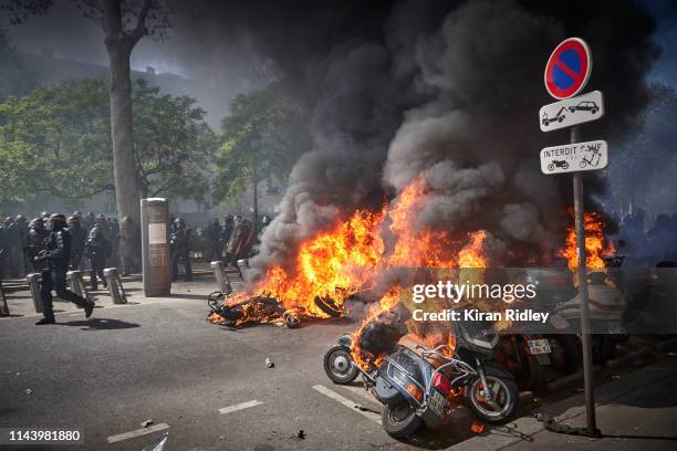 French Riot Police move past a line of burning vehicles during widespread rioting, violence and fire in Act 23 of Gilets Jaunes or 'Yellow Vest'...