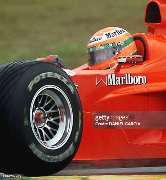 Irish Formula One driver, Eddie Irvine, powers his Ferrari through the "S of Senna" turn 09 April,1999 at the Interlagos race track, in Sao Paulo,...