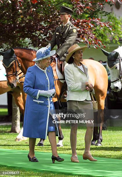 Britain's Queen Elizabeth II views horses and riders from the Irish Army Equitation school with Chryss O'Reilly, Chair of the board of the Irish...