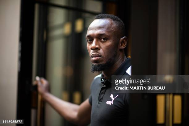 Jamaican Olympic sprinter Usain Bolt poses during a photo session as he launches a new brand of electric scooters named "Bolt" in Paris, on May 15,...