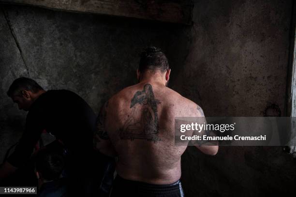 Flagellant, his back tattooed with the image of the body of Jesus on the lap of his mother Mary after the Crucifixion, prepares himself to take part...