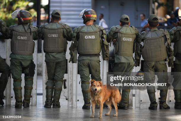 Members of Venezuela's Bolivarian National Guard block access to the Federal Legislative Palace, which houses both the opposition-led National...