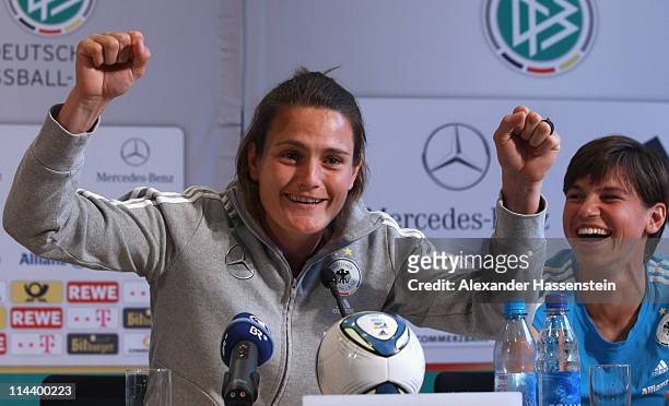 Nadine Angerer attends with her team mate Ariane Hingst of the German woman national team a press conference at the adidas headquater on May 19, 2011...