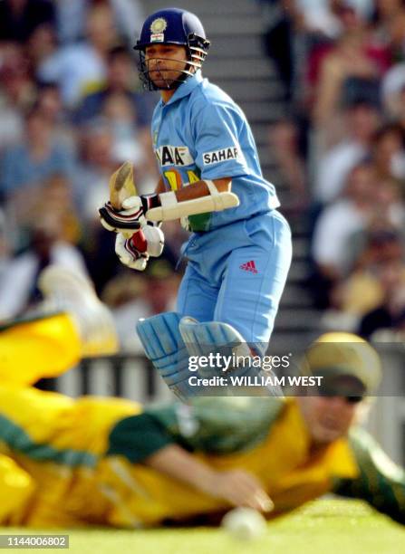 Indian batsman Sachin Tendulkar clips the ball away past diving Australian fieldsman Michael Clarke during their one-day match at the MCG in...