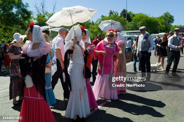 People dressed in the typical costumes of Chulapo and Chulapa visit 'La Pradera de San Isidro' park to mark St. Isidro, Madrid's patron saint day, in...