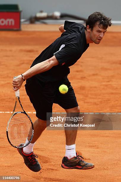 Philipp Petzschner of Germany plays a backhand during the blue group match between Philipp Petzschner of Germany and Igor Andreev of Russia during...