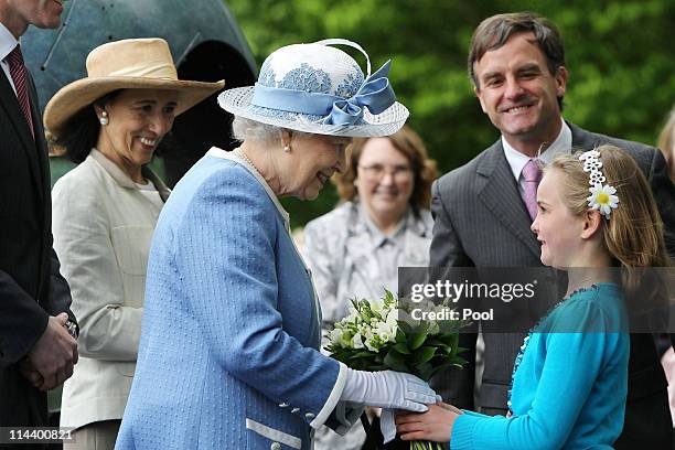 Queen Elizabeth II receives flowers from Emma Osbourne with John Osbourne, CEO of The Irish National Stud and Chryss O'Reilly , Chair of the Board of...