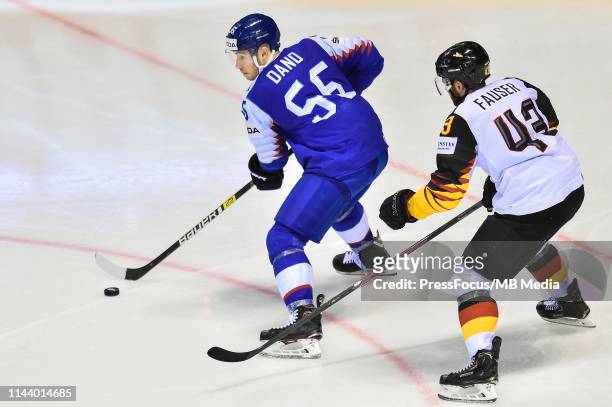 Yasin Ehliz of Germany checks Marko Dano of Slovakia during the 2019 IIHF Ice Hockey World Championship Slovakia group A game between Germany and...
