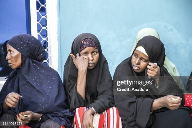 Somalian women wait to receive food aids distributed by Turkiye Diyanet Foundation within holy month of Ramadan in Mogadishu, Somalia on May 15, 2019.