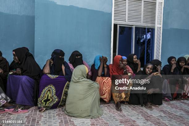 Somalian women wait to receive food aids distributed by Turkiye Diyanet Foundation within holy month of Ramadan in Mogadishu, Somalia on May 15, 2019.