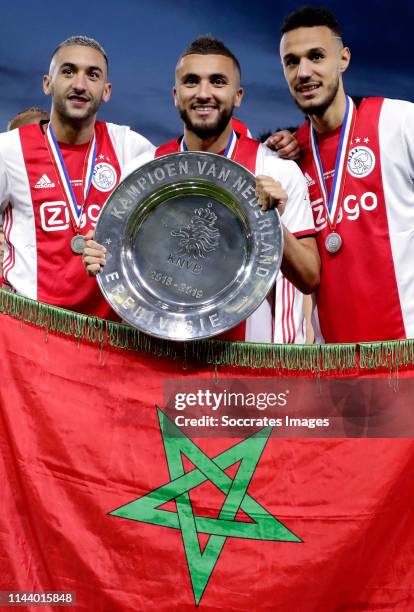 Hakim Ziyech of Ajax, Zakaria Labyad of Ajax, Noussair Mazraoui of Ajax celebrates the championship with the Eredivisie Trophy during the Dutch...