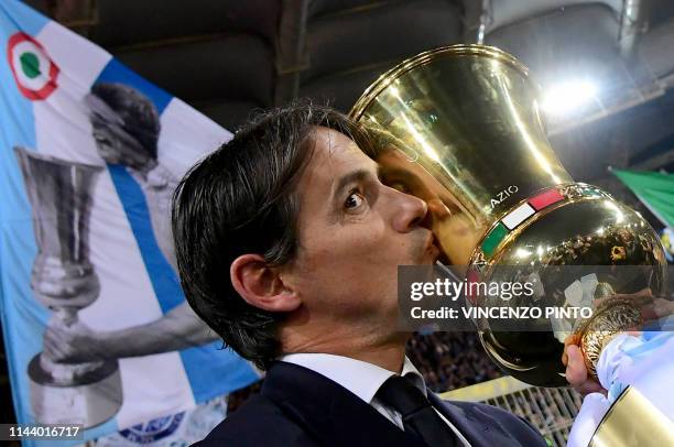 Lazio's Italian coach Simone Inzaghi kisses the Tim Cup trophy during the trophy ceremony after winning the Coppa Italia final match between Lazio...