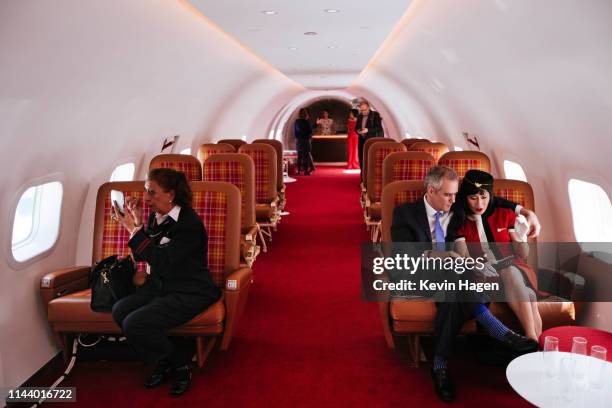 Visitors sit in the cabin of "Connie," the 1958 Lockheed Constellation airplane restored as a cocktail lounge at the newly opened TWA Hotel at JFK...