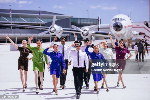 Models in aviation-inspired uniforms wave of "Connie," the 1958 Lockheed Constellation airplane restored as a cocktail lounge at the newly opened TWA...