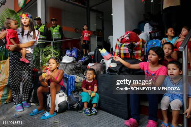 Relatives of Venezuelan soldiers and policemen who deserted to Colombia stay outside a hotel where they were staying in after being evicted in...