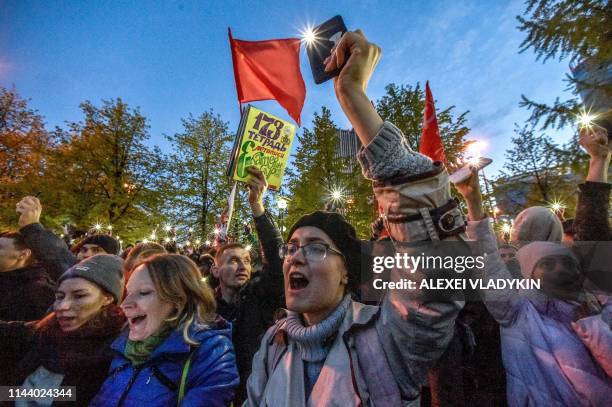 Activists protesting against a plan to build an Orthodox cathedral rally at a construction site in a park in the Russian Urals city of Yekaterinburg...