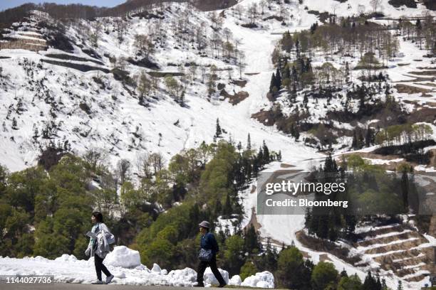 Visitors walk in a mountainous area of Yuzawa, Niigata Prefecture, Japan, on Tuesday, May. 7, 2019. For Japans growing flood of foreign tourists, one...