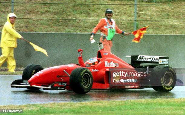 Germany's Ferrari driver Michael Schumacher crosses the finish line clenching his fist in victory after winning the Spainish Formula One Grand Prix...