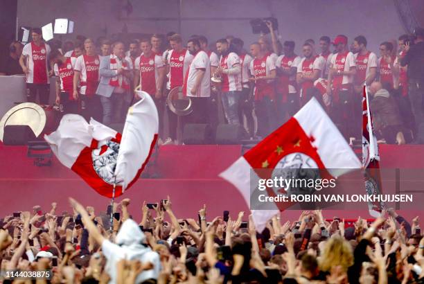 Ajax's players celebrate their 34th national champion title after winnning the 2019 Dutch Eredivisie championship outside the Museumplein in...