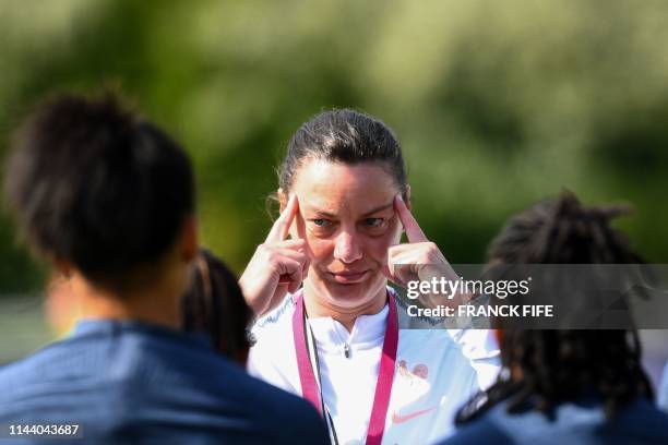 France's head coach Corinne Diacre reacts as she leads her team players in a training session in Clairefontaine-en-Yvelines on May 16 as part of the...