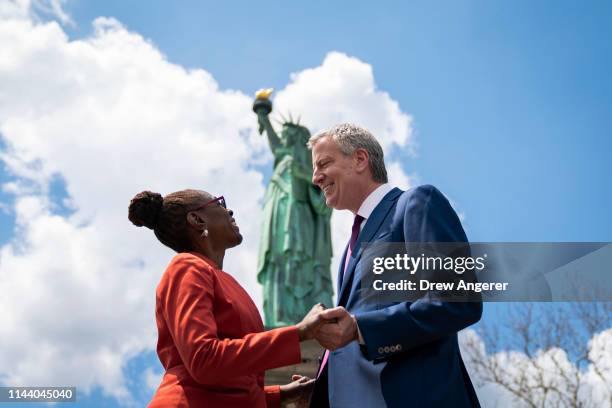 New York City Mayor Bill de Blasio and his wife Chirlane McCray stop in front of the Statue of Liberty following a dedication ceremony for the new...