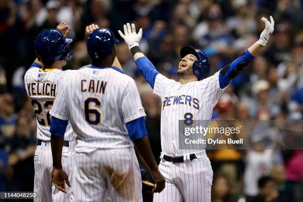 Christian Yelich, Lorenzo Cain, and Ryan Braun of the Milwaukee Brewers celebrate after Braun hit a home run in the seventh inning against the Los...