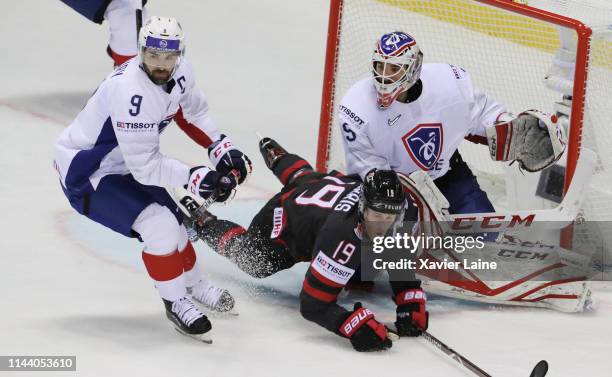 Damien Fleury and Henri-Corentin Buysse of France in action with Captain Kyle Turris of Canada during the 2019 IIHF Ice Hockey World Championship...