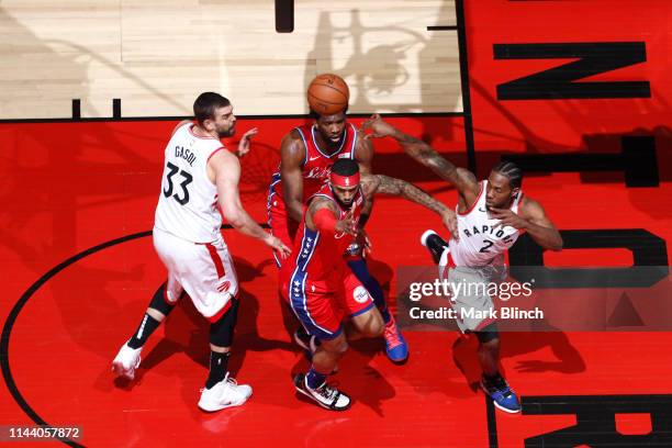 Kawhi Leonard passes the ball to Marc Gasol of the Toronto Raptors over Mike Scott of the Philadelphia 76ers during Game Seven of the Eastern...