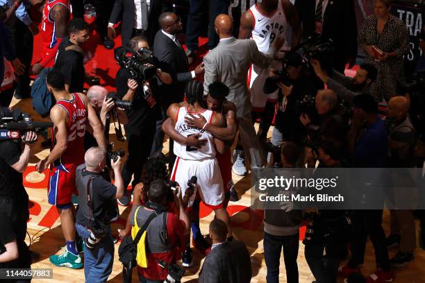 Kawhi Leonard of the Toronto Raptors hugs Jimmy Butler of the Philadelphia 76ers after Game Seven of the Eastern Conference Semifinals of the 2019...