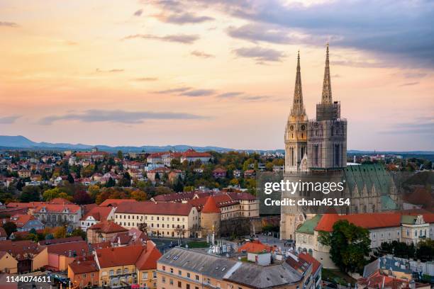 the beautiful church in zagreb with the old buildings in old city among the sunrise in croatia, europe. - zagreb - fotografias e filmes do acervo