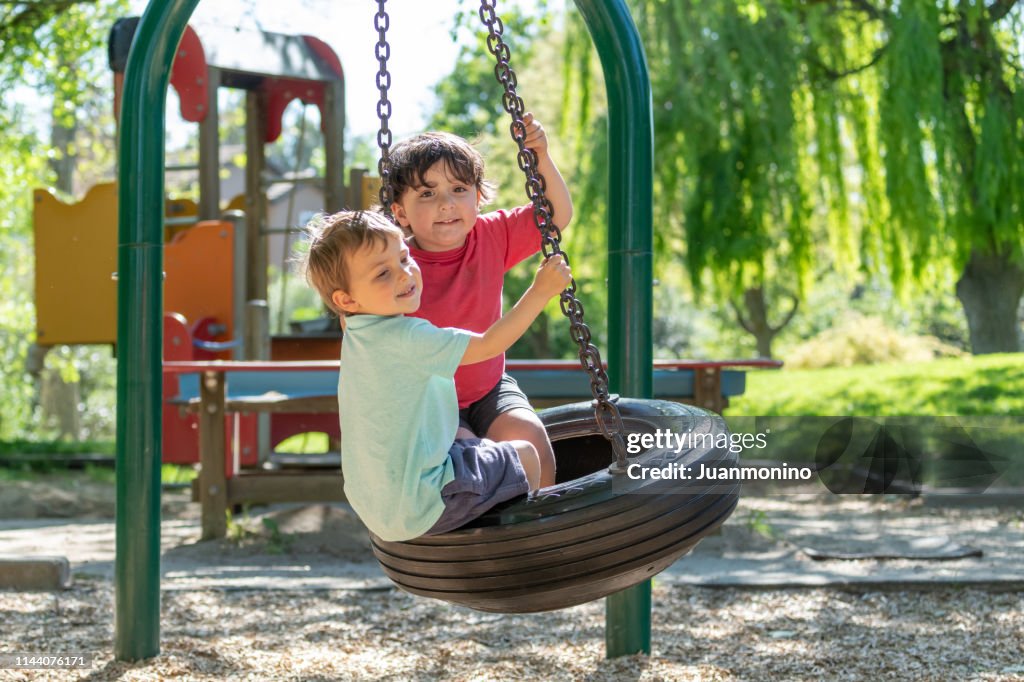 Three years old children playing in the park playground