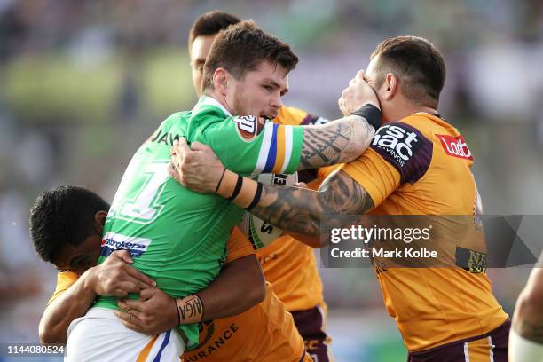 John Bateman of the Raiders fends off Jack Bird of the Broncos during the round 6 NRL match between the Canberra Raiders and the Brisbane Broncos at...