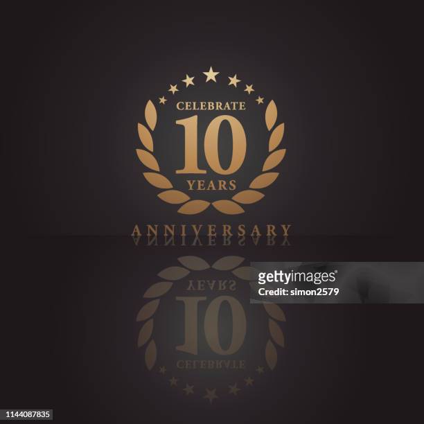 ten years golden anniversary icon with dark color background - anniversary stock illustrations