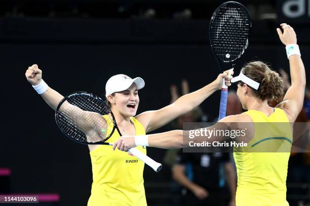 Samantha Stosur and Ashleigh Barty of Australia celebrate winning their doubles match against Victoria Azarenka and Aryna Sabalenka of Belarus during...