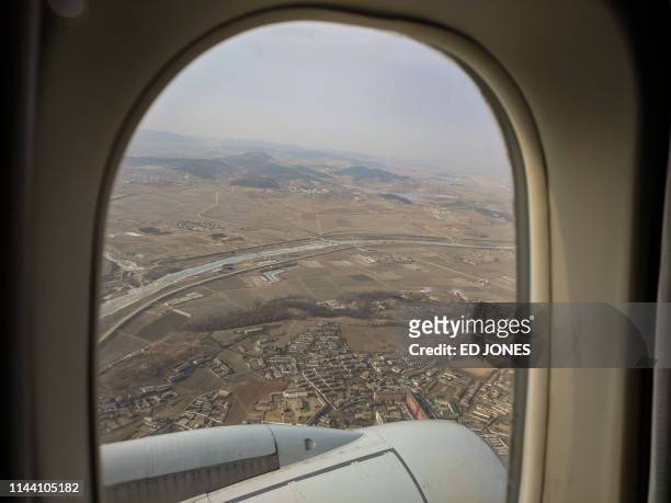 Photo taken on Febraury 12, 2019 shows a general view of the landscape and farmland north of Pyongyang from the window of an aircraft. - From January...