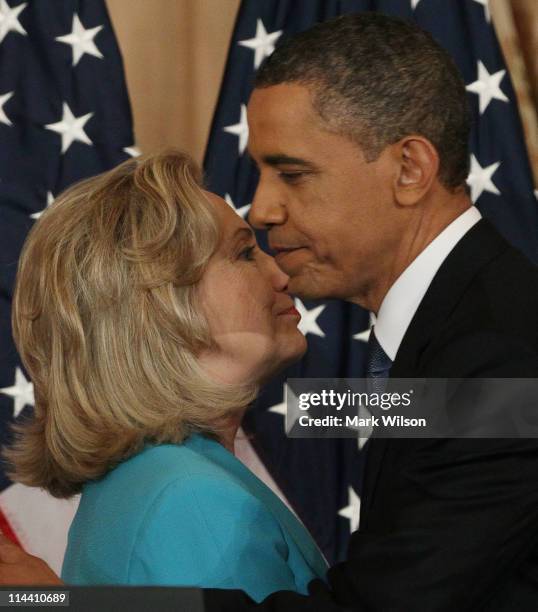 Secretary of State Hillary Clinton greets President Barack Obama after introducing him before a speech at the State Department on May 19, 2011 in...