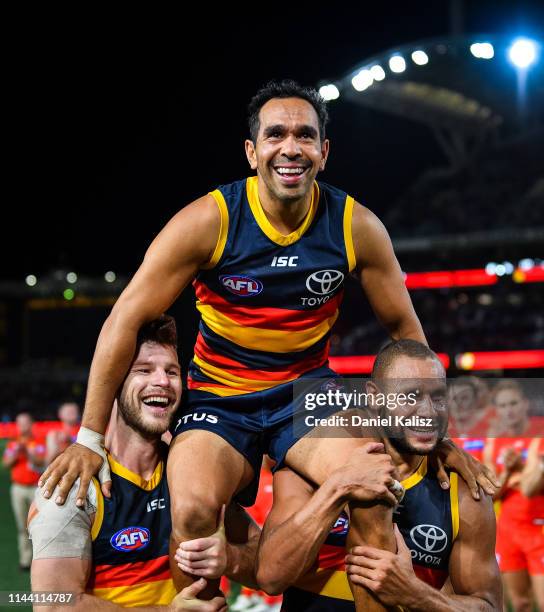 Eddie Betts of the Crows is chaired from the ground by Bryce Gibbs of the Crows and Cam Ellis-Yolmen of the Crows after playing his 300th AFL game...