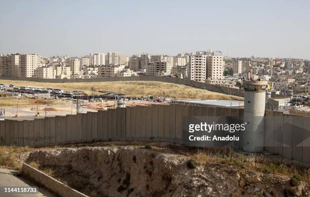 Separation wall is seen as Palestinians cross Qalandiya checkpoint to perform the second Friday Prayer of Islamic holy month of Ramadan at the...