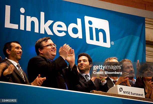 Reid Hoffman, chairman and co-founder of LinkedIn Corp., second from left, and Jeffrey Weiner, chief executive officer of LinkedIn, center, applaud...