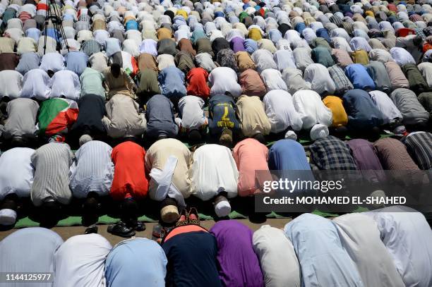 Sudanese protesters take part in the Friday prayers near the military headquarters in the capital Khartoum on May 17 during an ongoing sit-in...