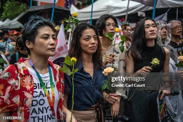 Women hold roses as they await the result of a parliamentary vote to legalise same-sex marriage on May 17, 2019 in Taipei, Taiwan. Taiwan became the...