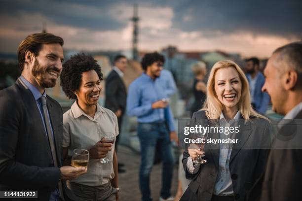 cheerful business colleagues communicating at the outdoor party. - outdoor party imagens e fotografias de stock