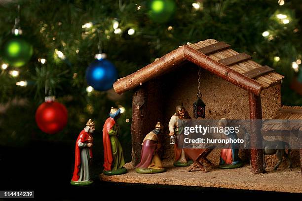 nativity scene next to a christmas tree - julkrubba bildbanksfoton och bilder